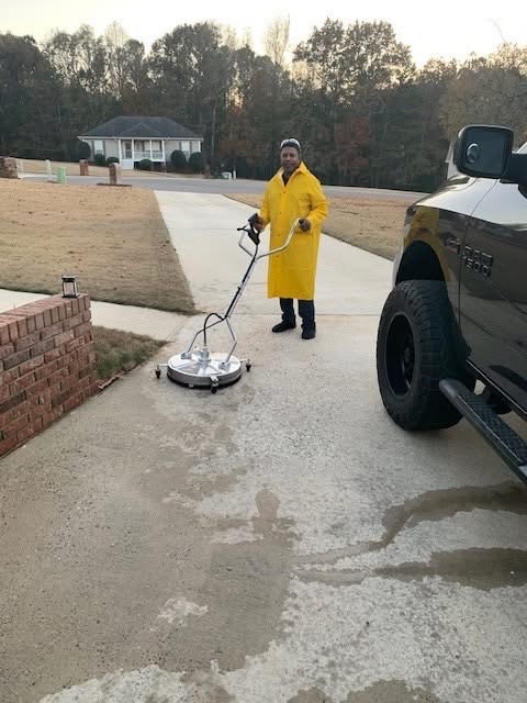 Surface cleaner lifting grime from a concrete driveway