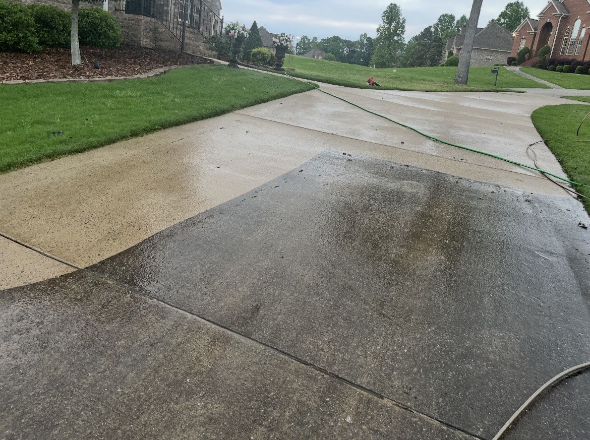 Half-cleaned driveway showing the bright results