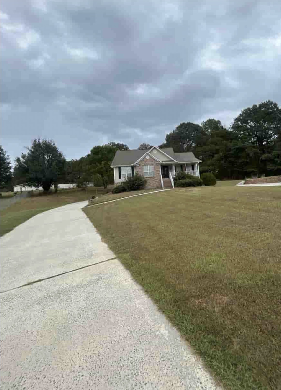 Ranch home with a freshly cleaned driveway